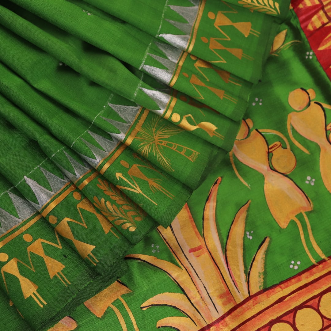 Close-up of green Patachitra silk saree, showcasing the handloom weave and fabric texture.