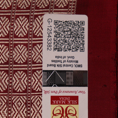Close-up of multicolored Sambalpuri silk saree fabric texture showing intricate weave and maroon accents.