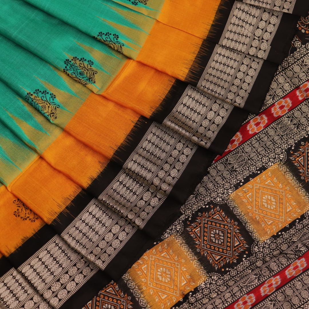 Close-up of yellow silk Bomkai saree fabric with black butta pattern