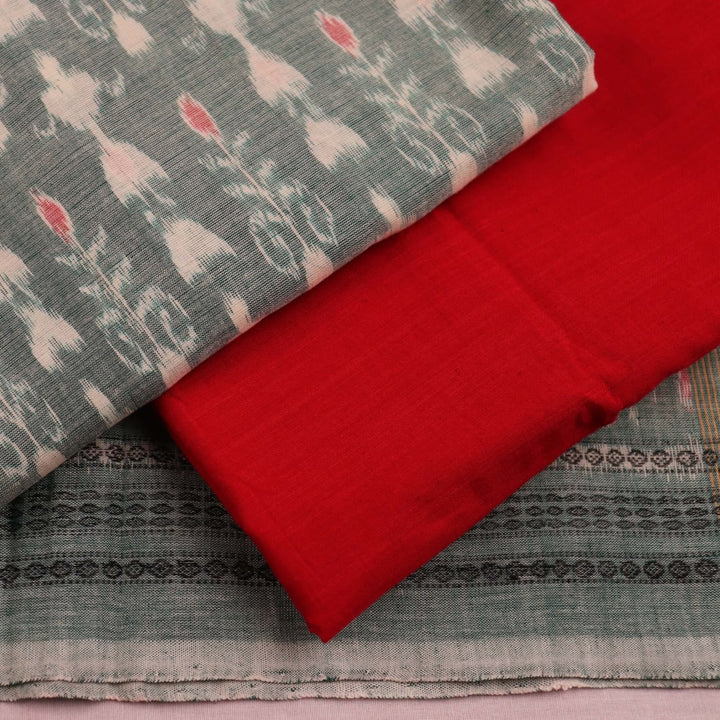 Close-up of a blouse piece in green and red cotton Sambalpuri fabric with motif patterns.