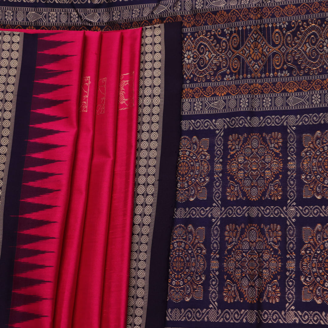 Close-up view of soft, lustrous silk fabric with intricate butta patterns in pink and blue