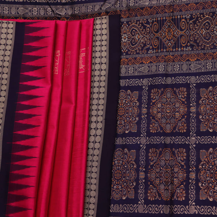 Close-up view of soft, lustrous silk fabric with intricate butta patterns in pink and blue