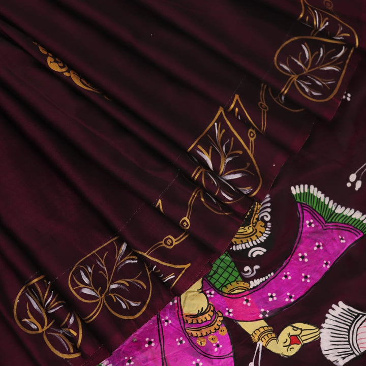 Close-up of a hand-painted silk Patachitra saree, highlighting the vibrant, textured weave and intricate details.