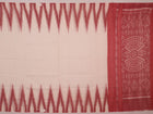 Model wearing a white and maroon Sambalpuri cotton saree with motifs, demonstrating a stylish drape.