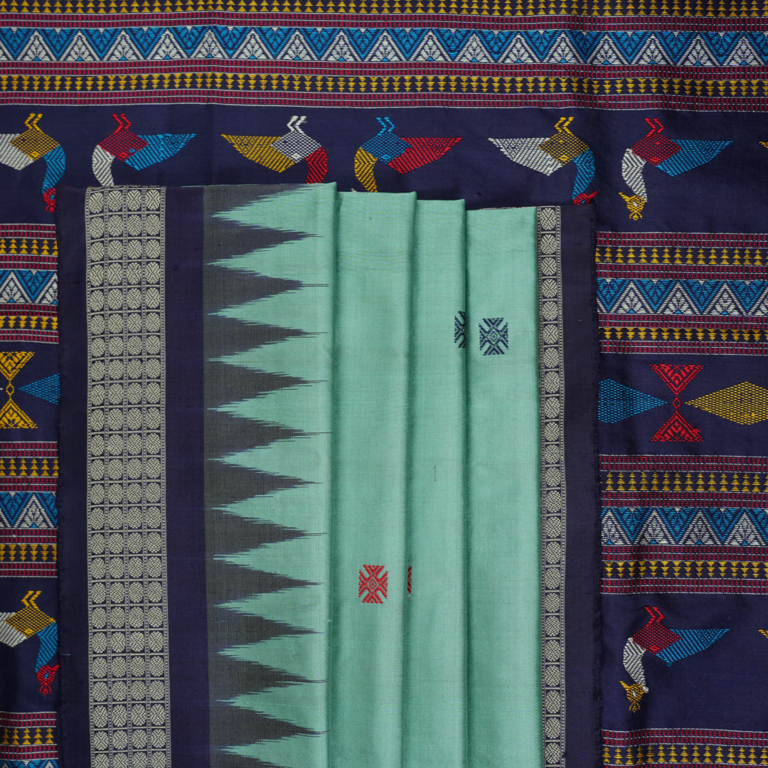 Extreme close-up revealing the rich texture and intricate weave of green Bomkai Silk fabric.