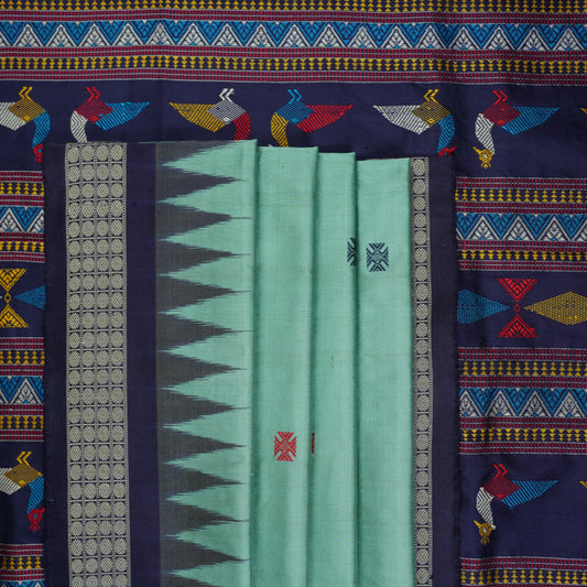 Extreme close-up revealing the rich texture and intricate weave of green Bomkai Silk fabric.