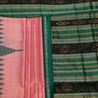 Close-up of the plain woven silk texture of a pink and green Sambalpuri saree.