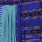 Close-up of plain blue Sambalpuri silk handloom saree fabric texture.