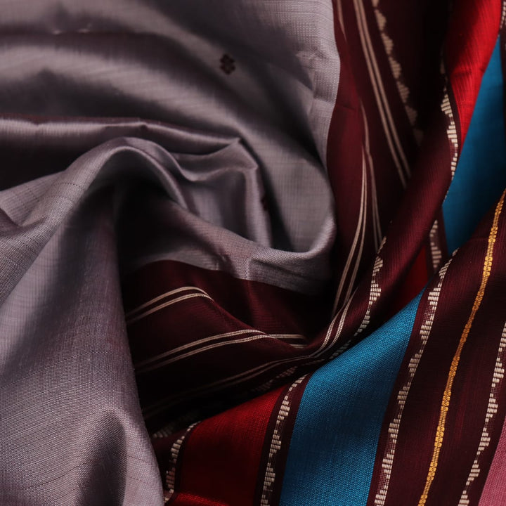 Close-up of silk fabric texture with butta design in grey and maroon