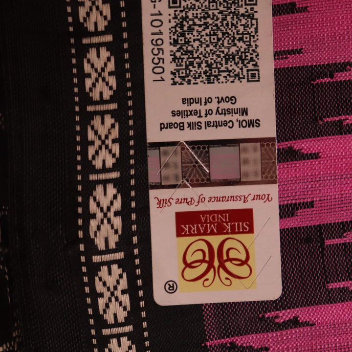 Close-up showcasing the intricate silk fabric texture of a pink and black Berhampuri silk saree with a butta pattern