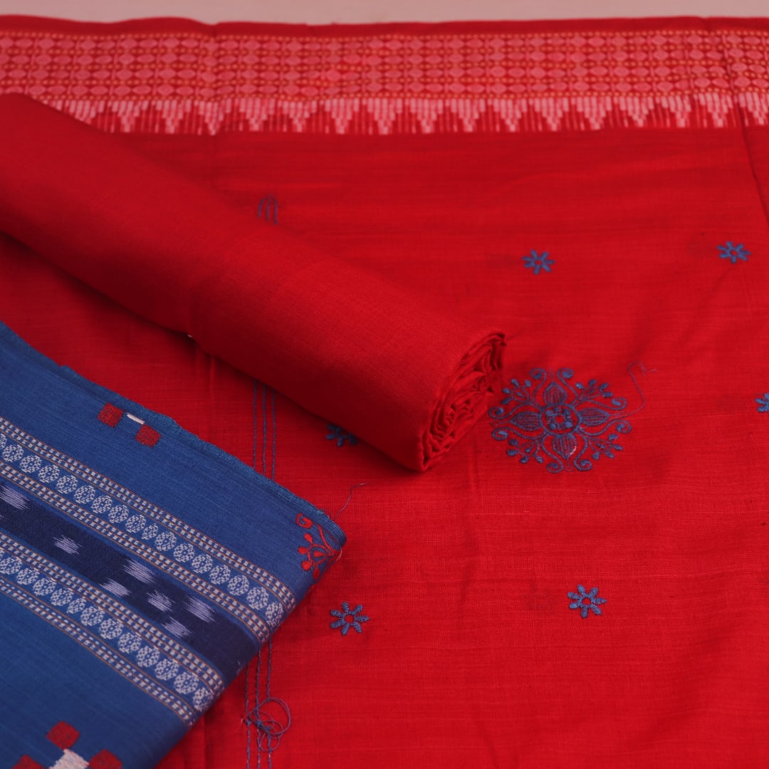 Sambalpuri cotton dress material: Close-up of blue blouse piece with red motifs.