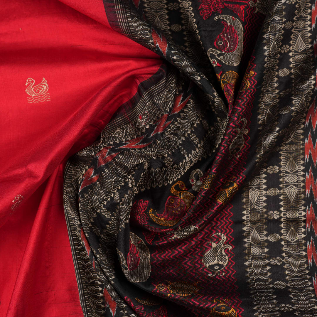 Extreme close-up revealing the fine handloom texture and intricate weave of the Bomkai silk fabric.