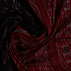 Black cotton Sambalpuri saree with red motifs, draped on a model