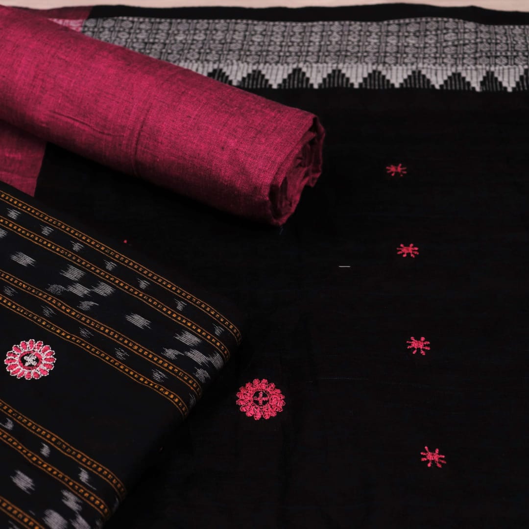 Close-up of blouse piece featuring intricate Sambalpuri motifs in black and magenta on a cotton base.