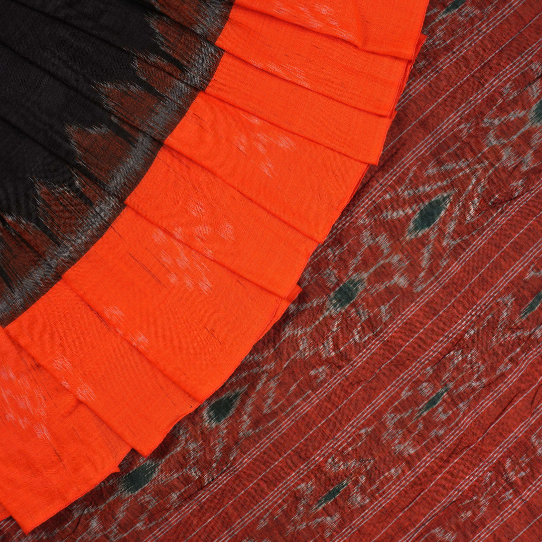 Elegant model styling of a black and orange Sambalpuri cotton saree showcasing the complete handloom look.