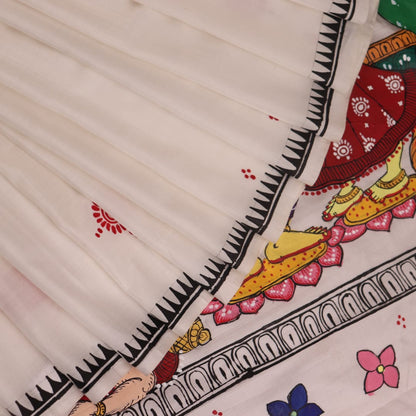 Close-up of handloom white silk Patachitra saree fabric showing texture and hand-painted details.