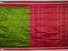 Textured close-up of green Bomkai silk saree fabric, revealing intricate weave and magenta butta pattern.