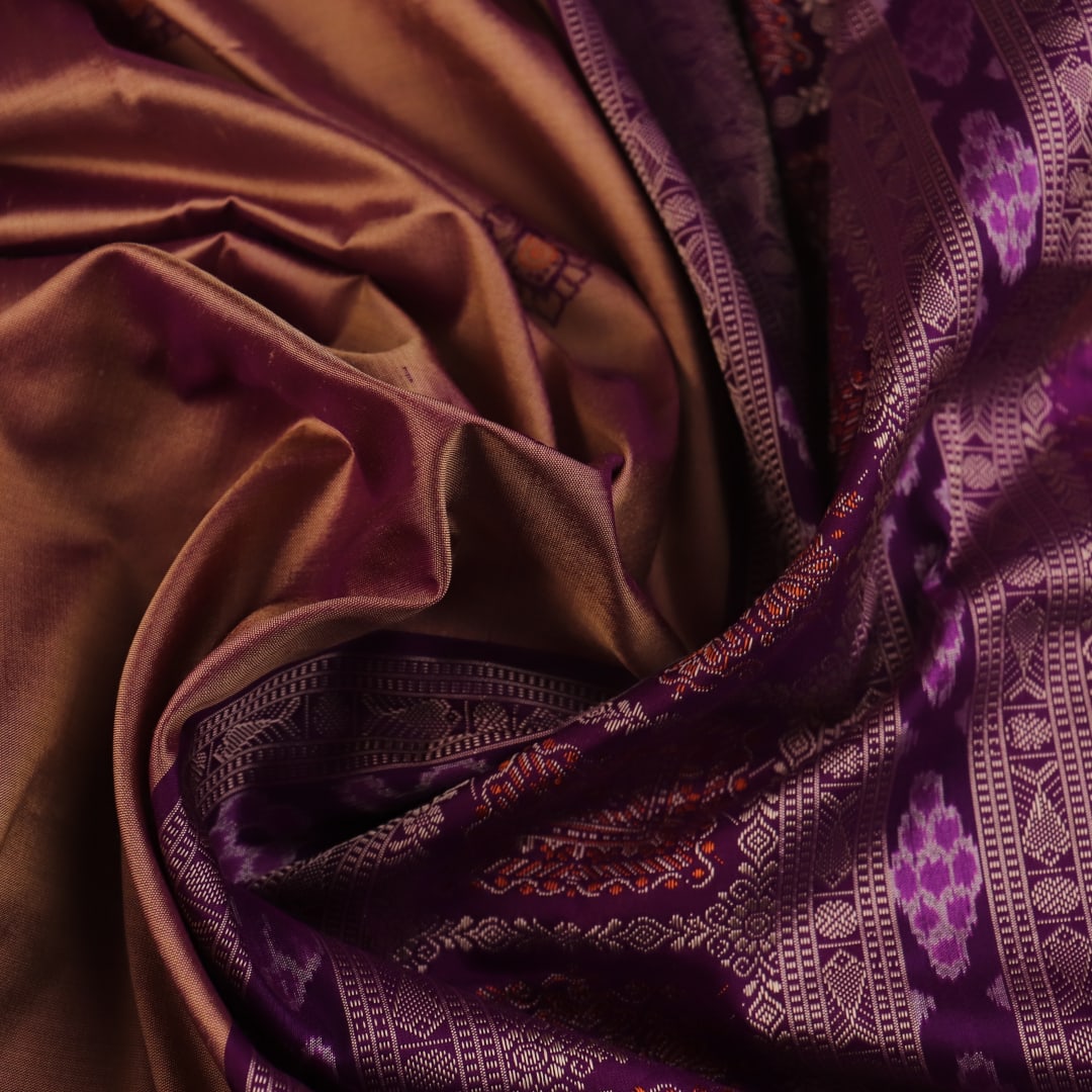 Close-up of the smooth, lustrous texture of multi-color and violet Bomkai silk saree, featuring butta weave.