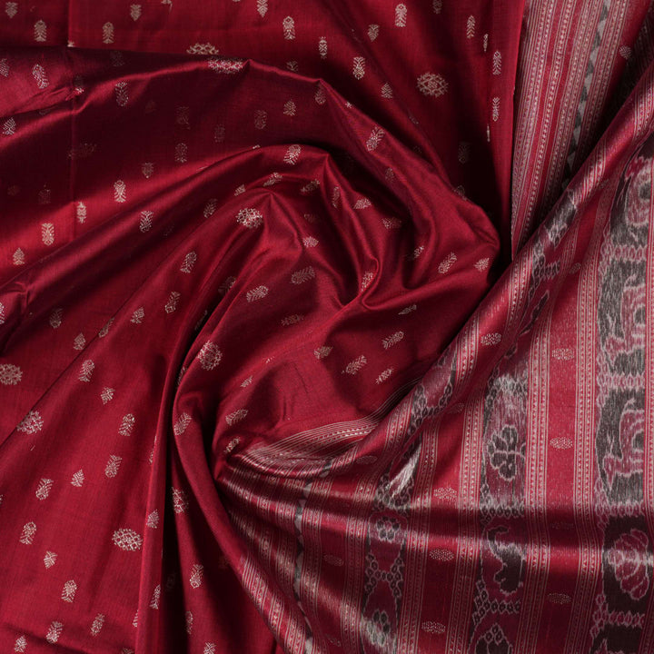 Extreme close-up revealing the rich texture and intricate handloom weave of the maroon and grey Sambalpuri silk fabric.