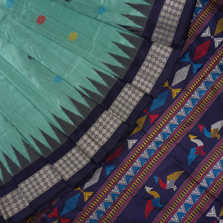 Extreme close-up revealing the rich texture and intricate weave of green Bomkai Silk fabric.