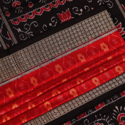 Close-up of red and black silk Sambalpuri saree fabric with intricate motifs