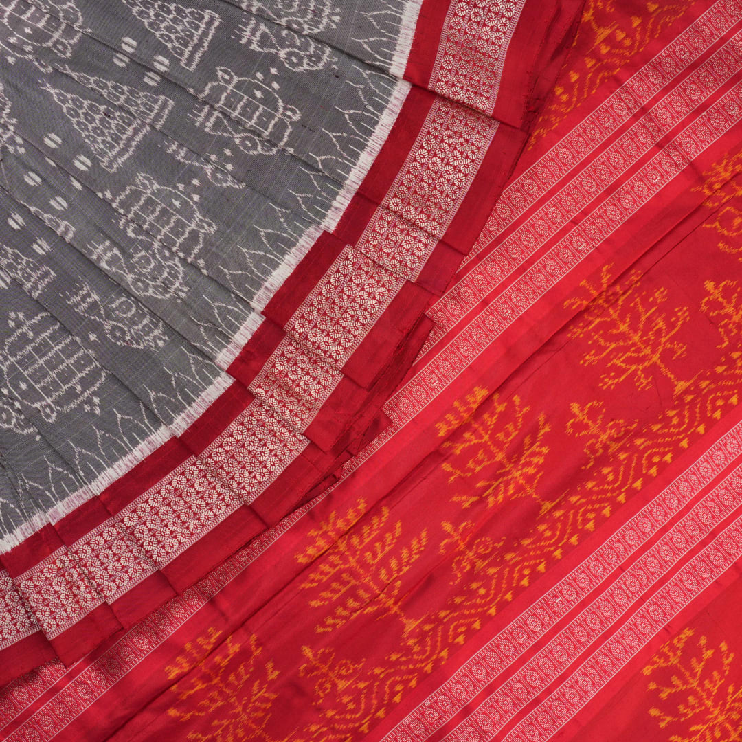 Close-up of the soft, lustrous grey Sambalpuri silk fabric texture, highlighting the intricate weave and motifs.