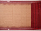Draped plain cream and maroon Sambalpuri cotton saree.