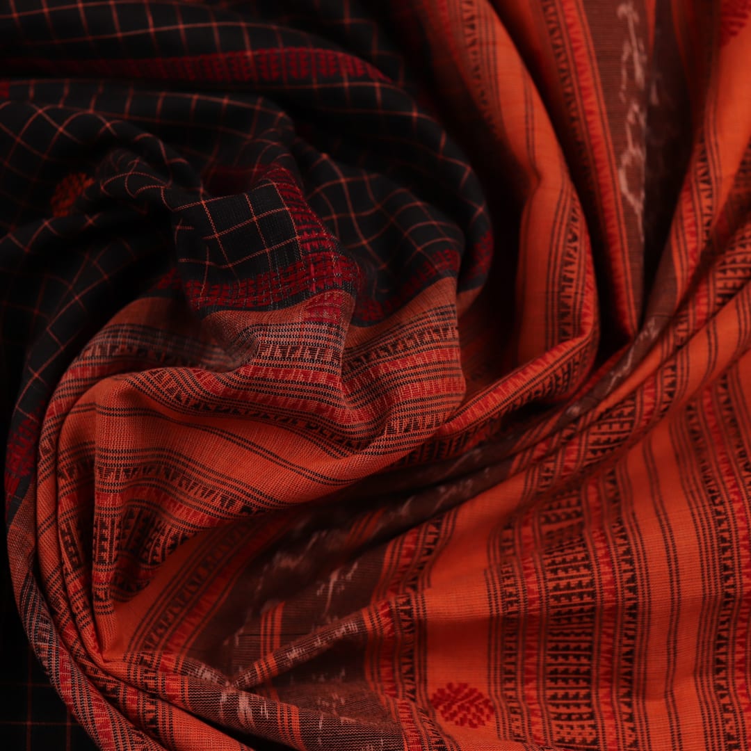 Full view of a Black and Orange Cotton Sambalpuri Saree with a Butta pattern.