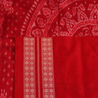 Close-up of grey and red Sambalpuri silk saree fabric showing intricate woven motif texture.