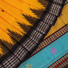 Close-up view of the golden silk fabric with black butta pattern of a Berhampuri silk saree