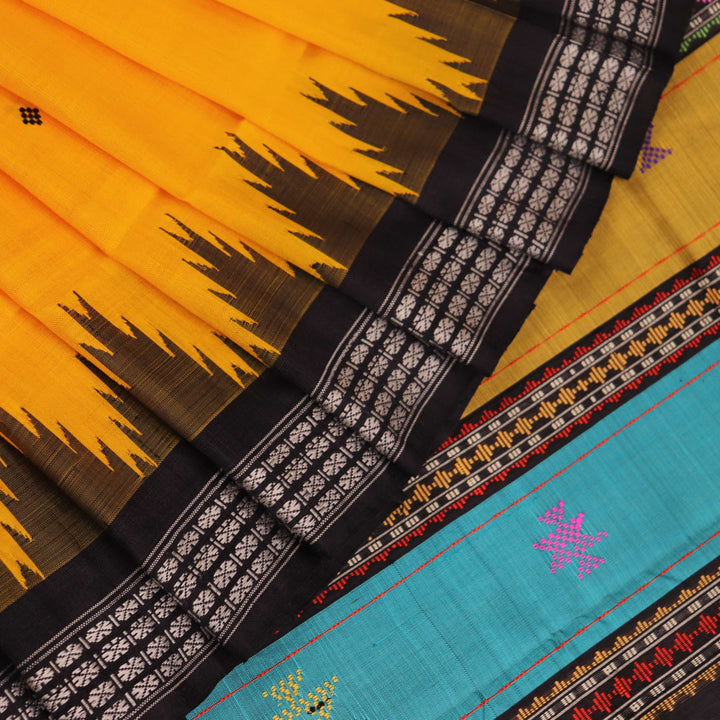 Close-up view of the golden silk fabric with black butta pattern of a Berhampuri silk saree