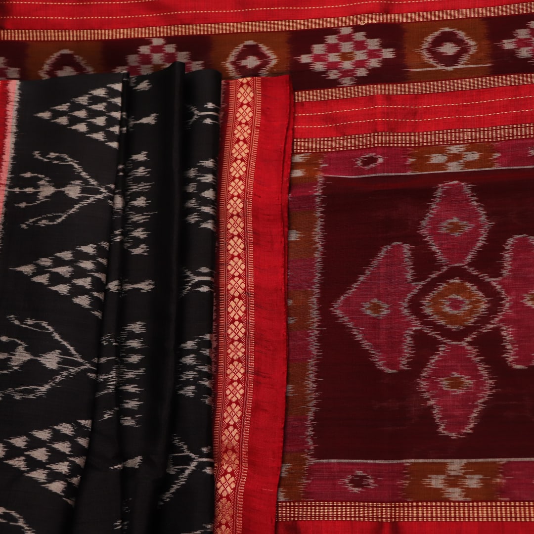 Full view of a black Khandua silk saree with red motifs.