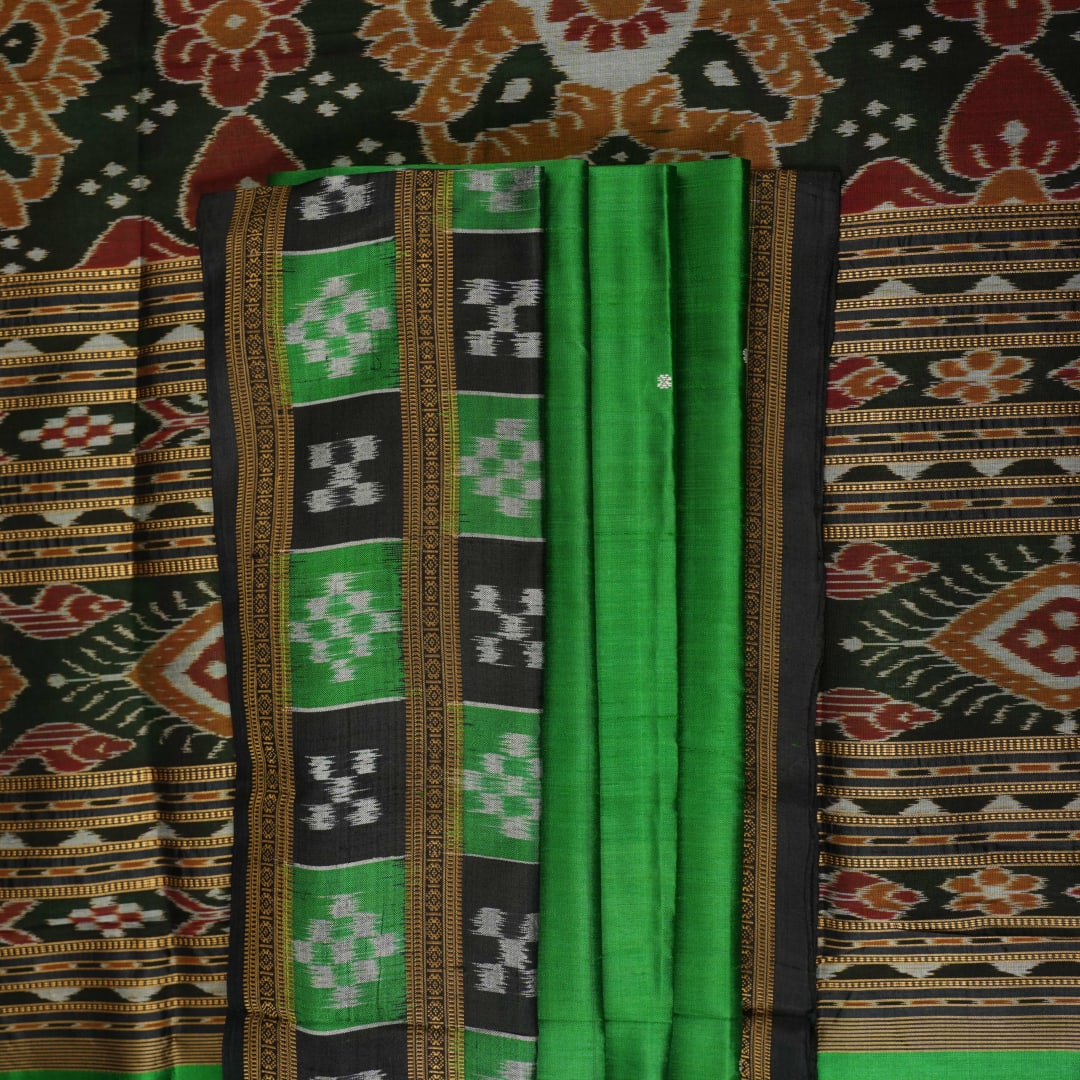 Model draped in a green and black Khandua silk saree with butta work, showcasing elegant ethnic styling.