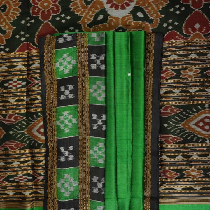 Model draped in a green and black Khandua silk saree with butta work, showcasing elegant ethnic styling.