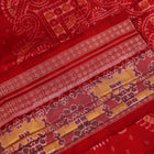 Close-up of multicolored silk Sambalpuri saree fabric showing intricate handloom weave texture.