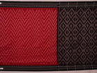 Red and black Sambalpuri cotton saree with motifs, elegantly draped.