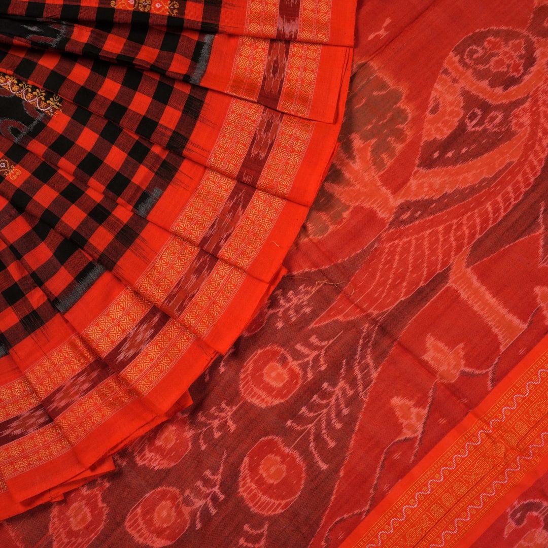 Full layout view of a black and orange Sambalpuri cotton saree showing the body, border, and pallu