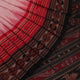 Woman draped in a white and black Sambalpuri cotton saree with motifs.