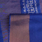 Close-up of blue printed Tussar silk handloom saree fabric texture.
