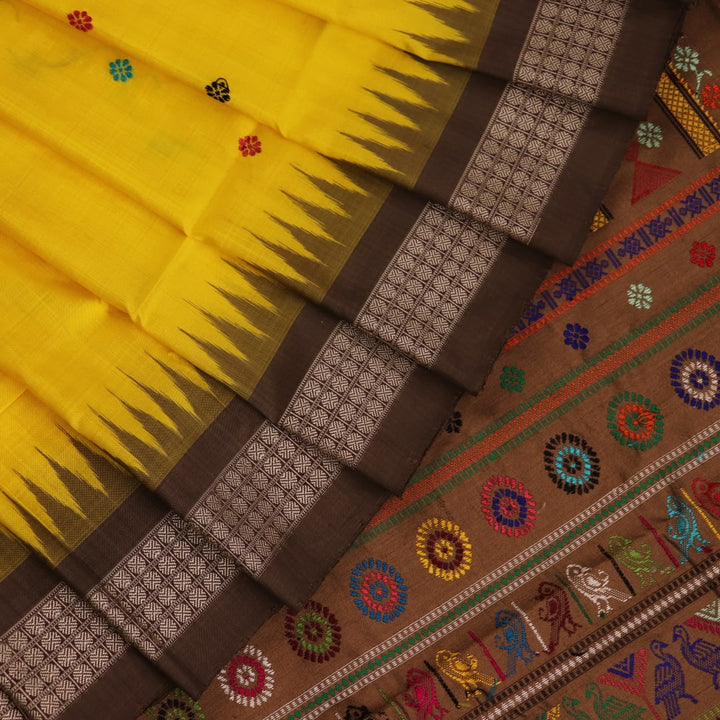 Close-up of Yellow and Brown Silk Saree fabric with Butta pattern