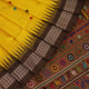 Close-up of Yellow and Brown Silk Saree fabric with Butta pattern