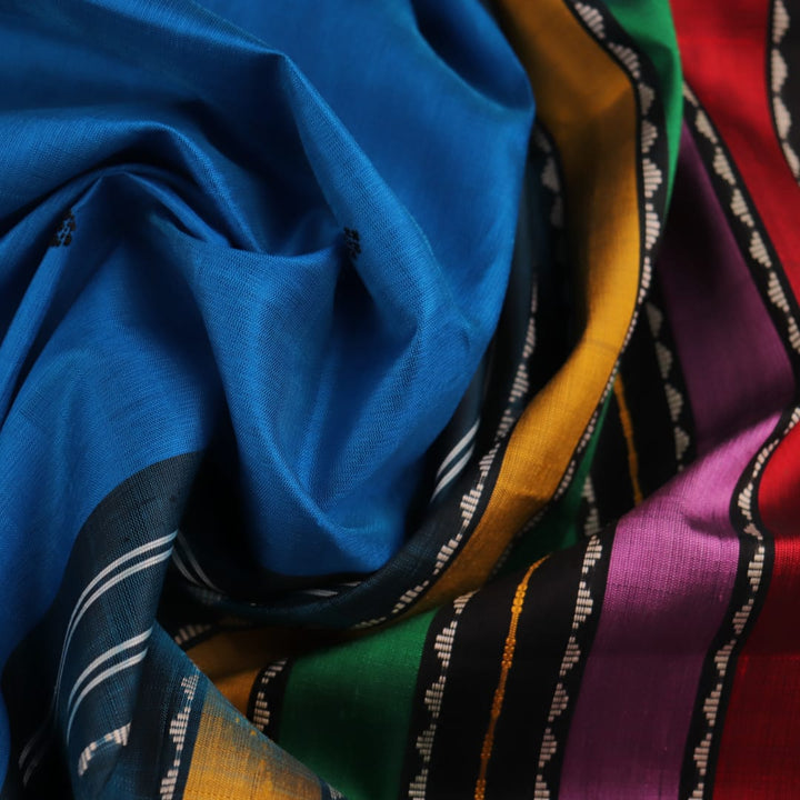 Close-up of intricate butta pattern on a silk blue and black Berhampuri saree