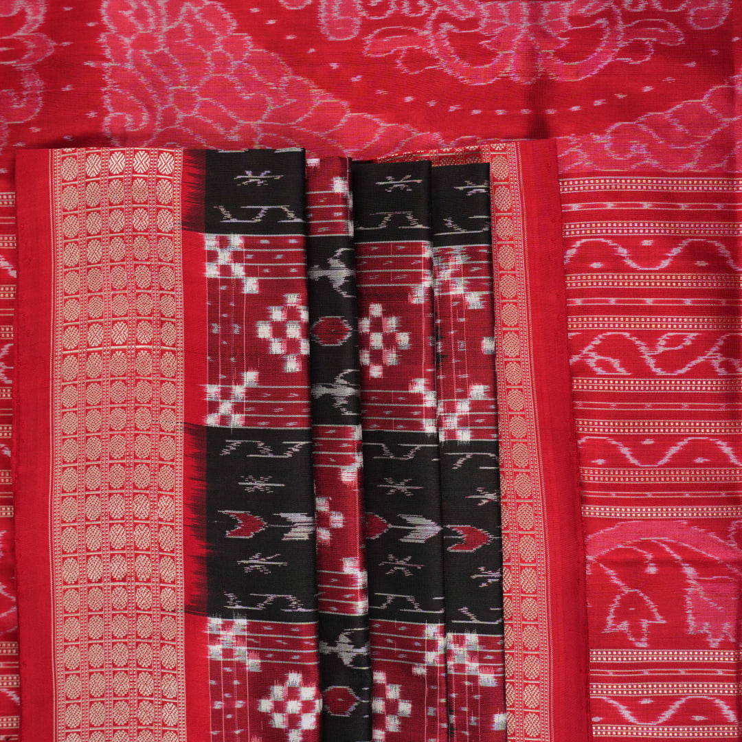 Close-up of the rich, smooth texture of the black Sambalpuri silk saree fabric.