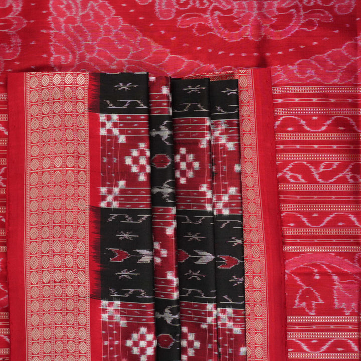 Close-up of the rich, smooth texture of the black Sambalpuri silk saree fabric.