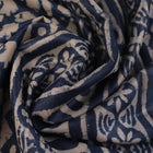 Close-up of blue printed Tussar silk saree fabric texture.
