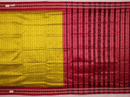 Close-up view of the soft silk fabric texture of a green and magenta Sambalpuri saree with intricate butta patterns