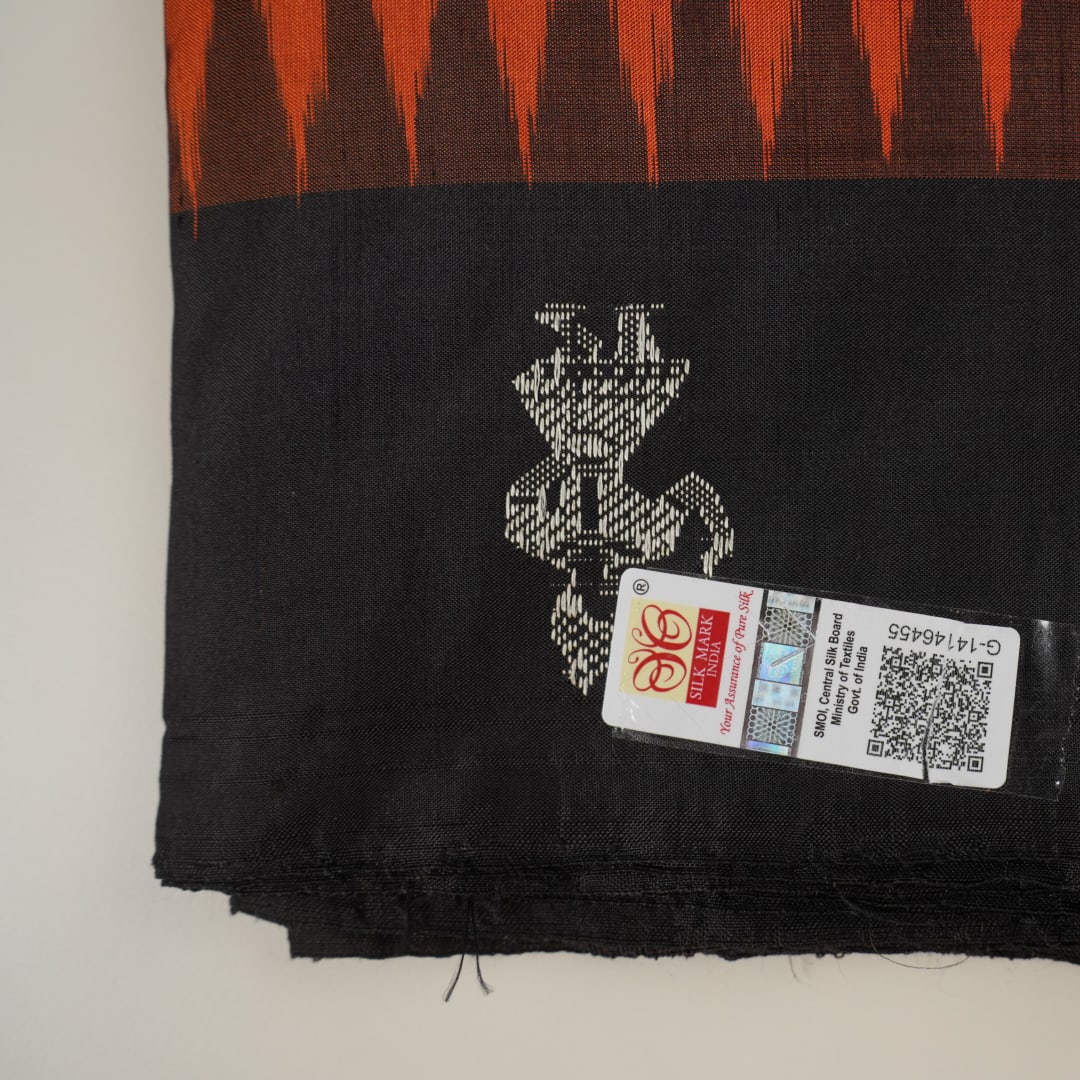 Ultra close-up of Bomkai Silk Saree fabric, revealing intricate handloom texture and butta weave details.