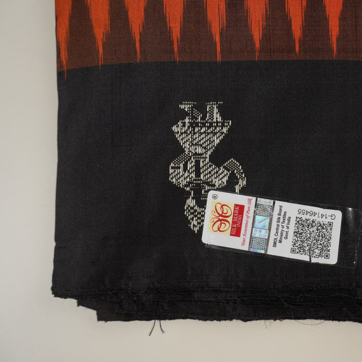 Ultra close-up of Bomkai Silk Saree fabric, revealing intricate handloom texture and butta weave details.