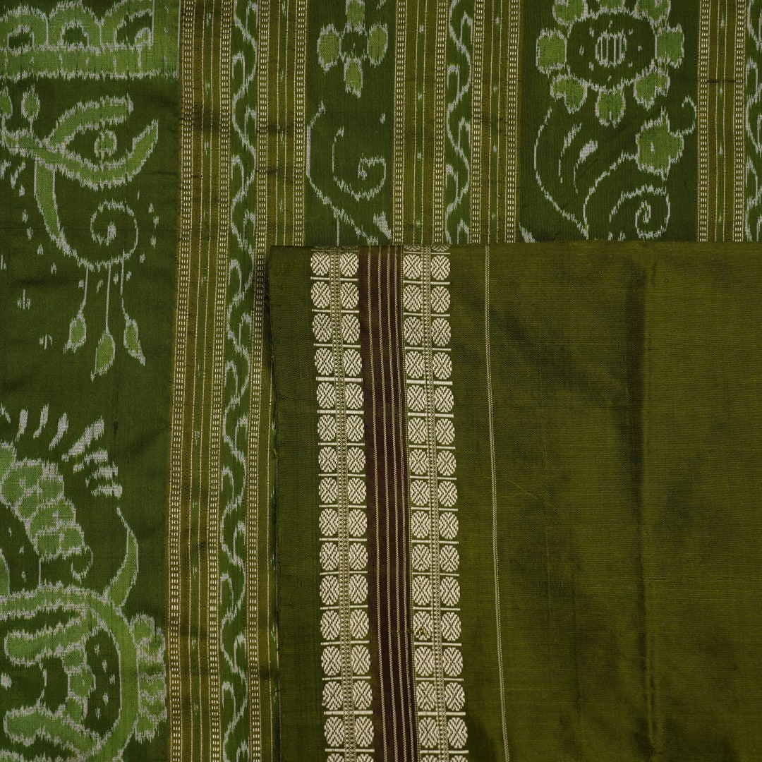 Extreme close-up of cream Sambalpuri silk saree showing exquisite handloom weave texture.