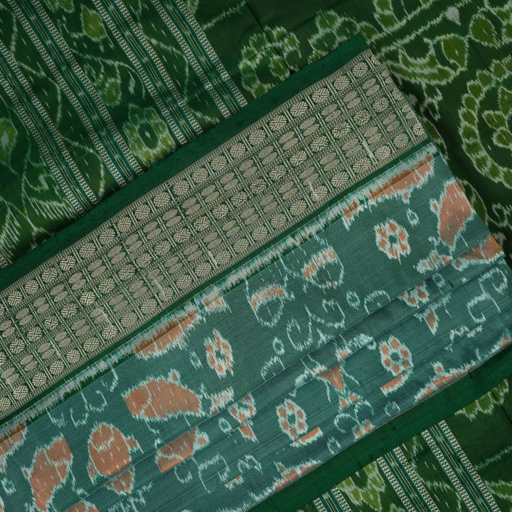 Ultra close-up of green Sambalpuri silk saree fabric, highlighting its luxurious texture and weave.